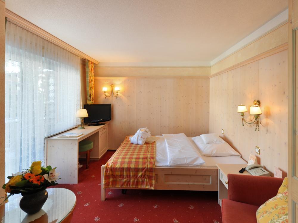 Cozy room at Resort La Ginabelle Zermatt with double bed and balcony