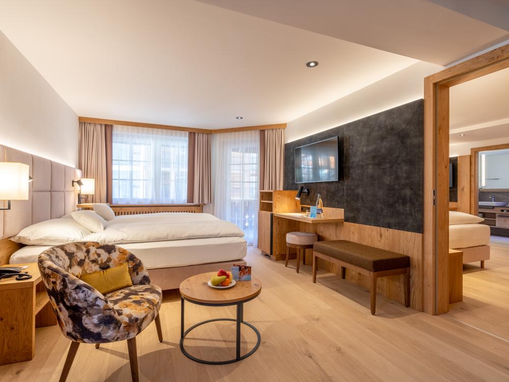 Modern room at Resort La Ginabelle Zermatt with cozy seating and balcony
