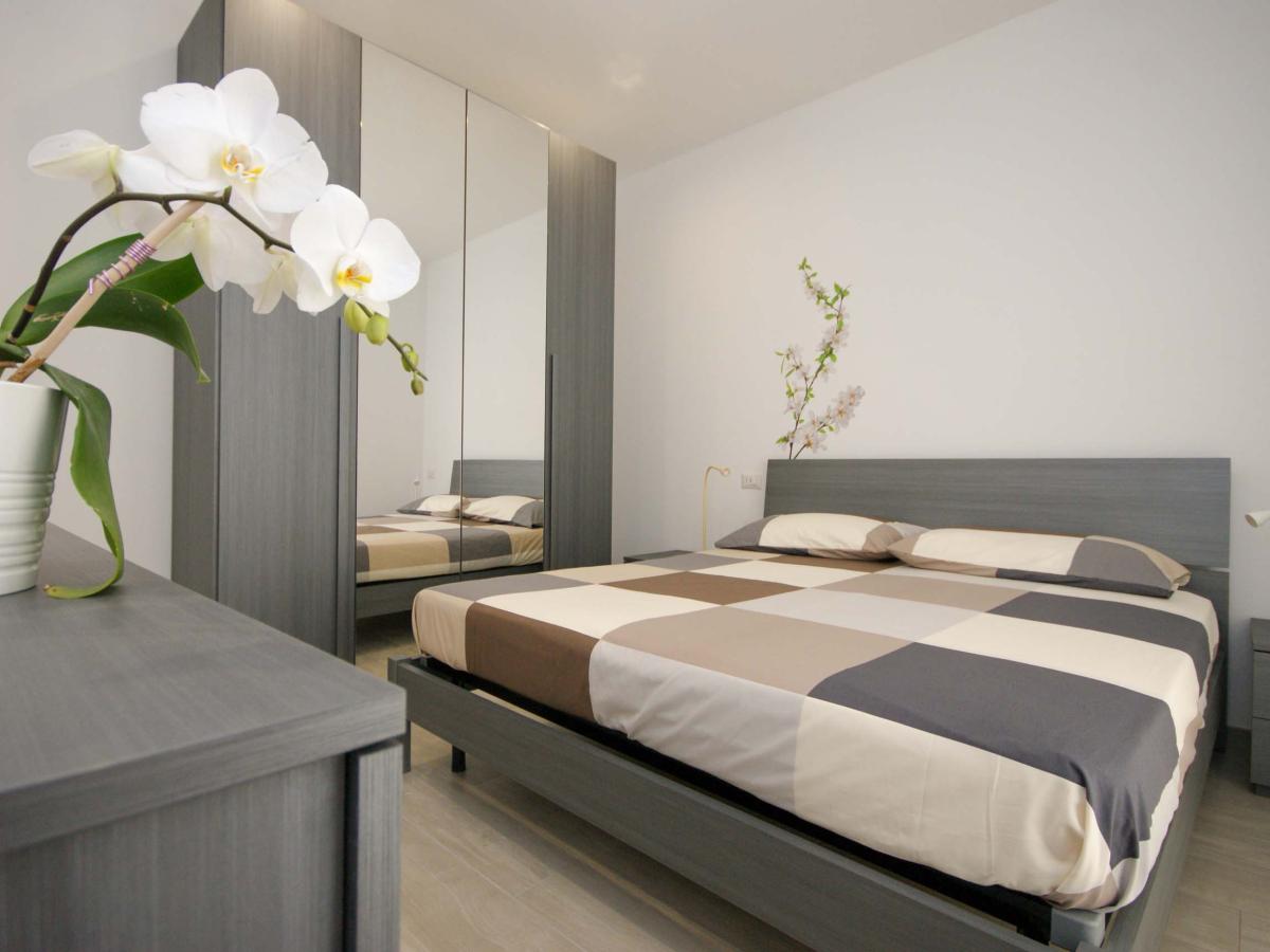 Camera da letto con letto matrimoniale e orchidea bianca in Evangelisti Casa Bellaria-Igea Marina