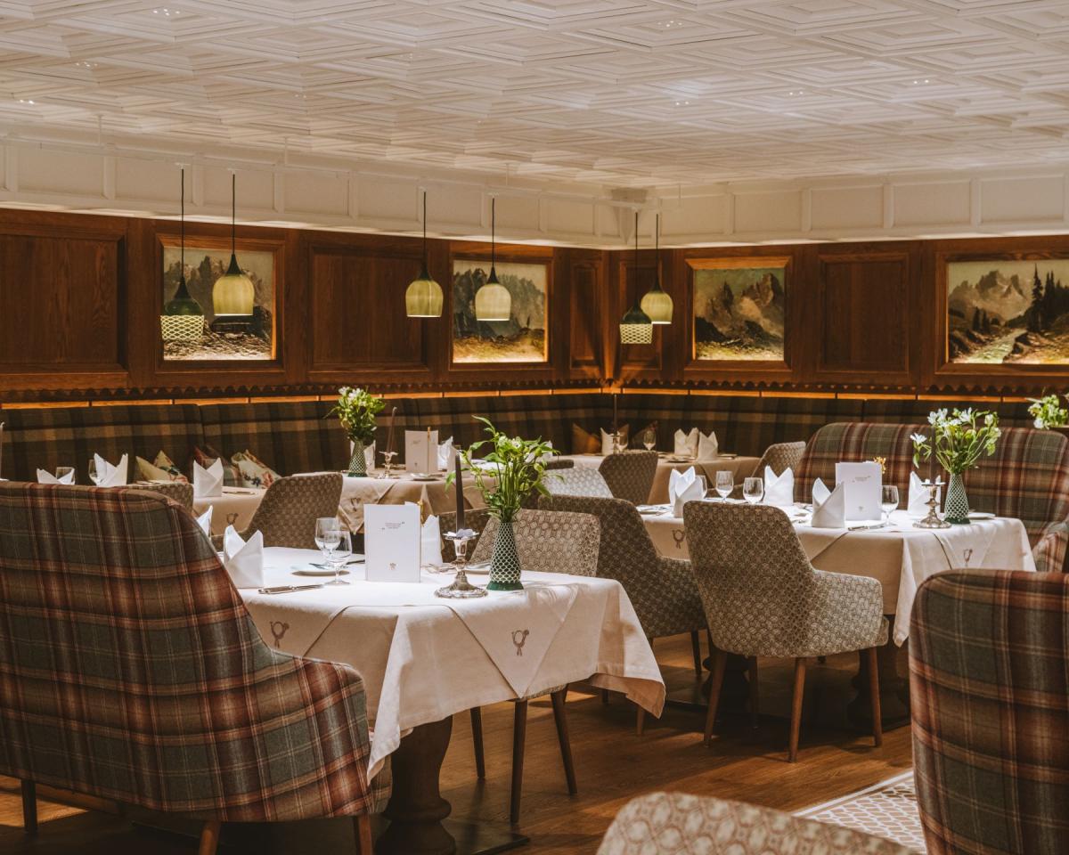 Cozy dining room at Hotel Post Lech with set tables and wooden walls