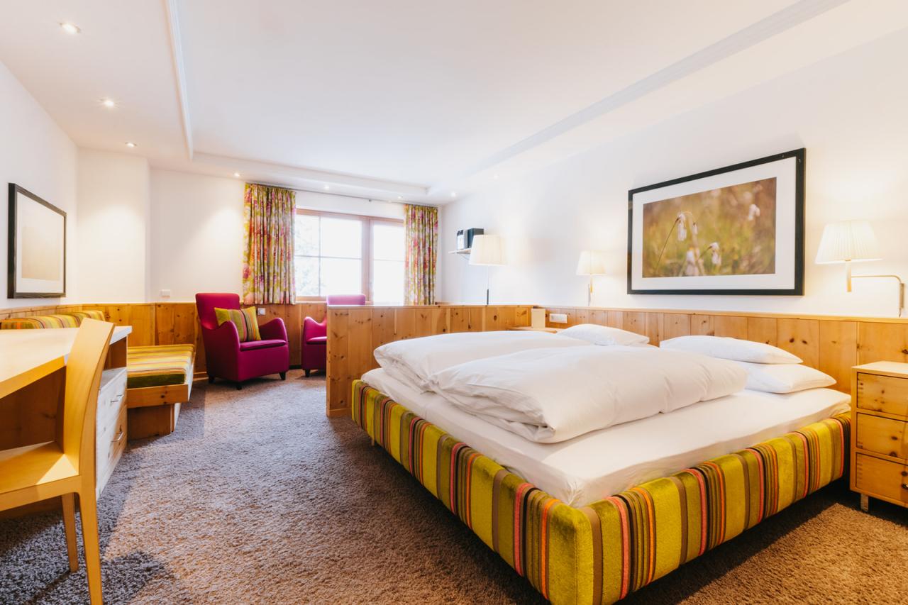 Cozy wall lamp and pillow at Hotel Aurora