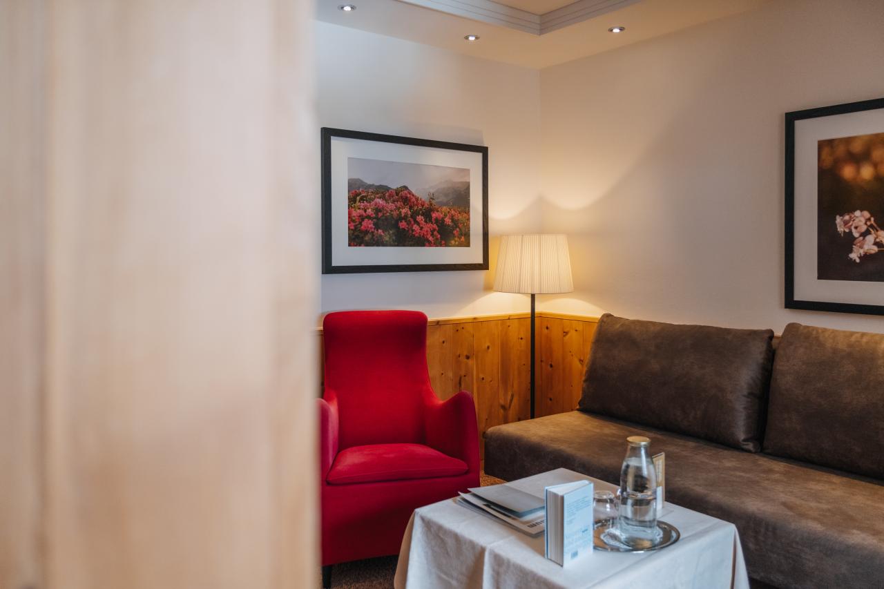 Room at Hotel Aurora with wooden walls and two single beds