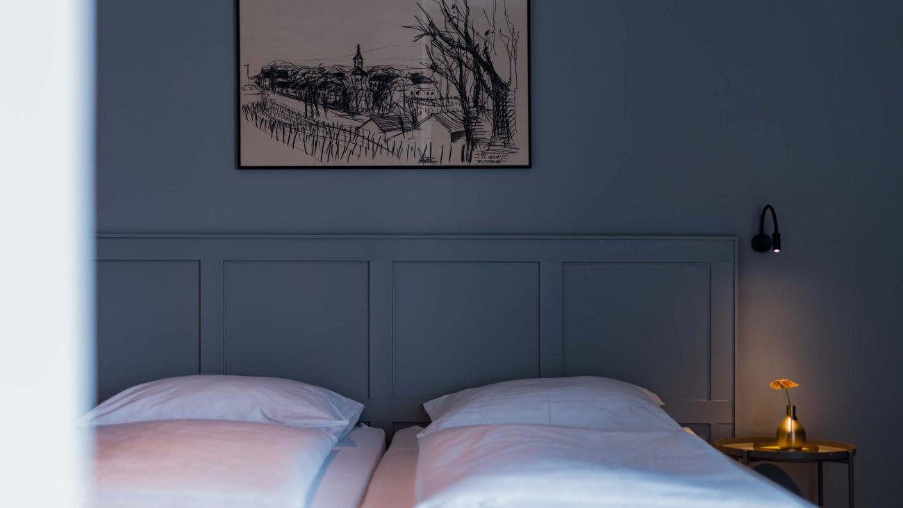 Schlafzimmer mit Luis v. Weyden Kunst über dem Bett und sanfter Beleuchtung