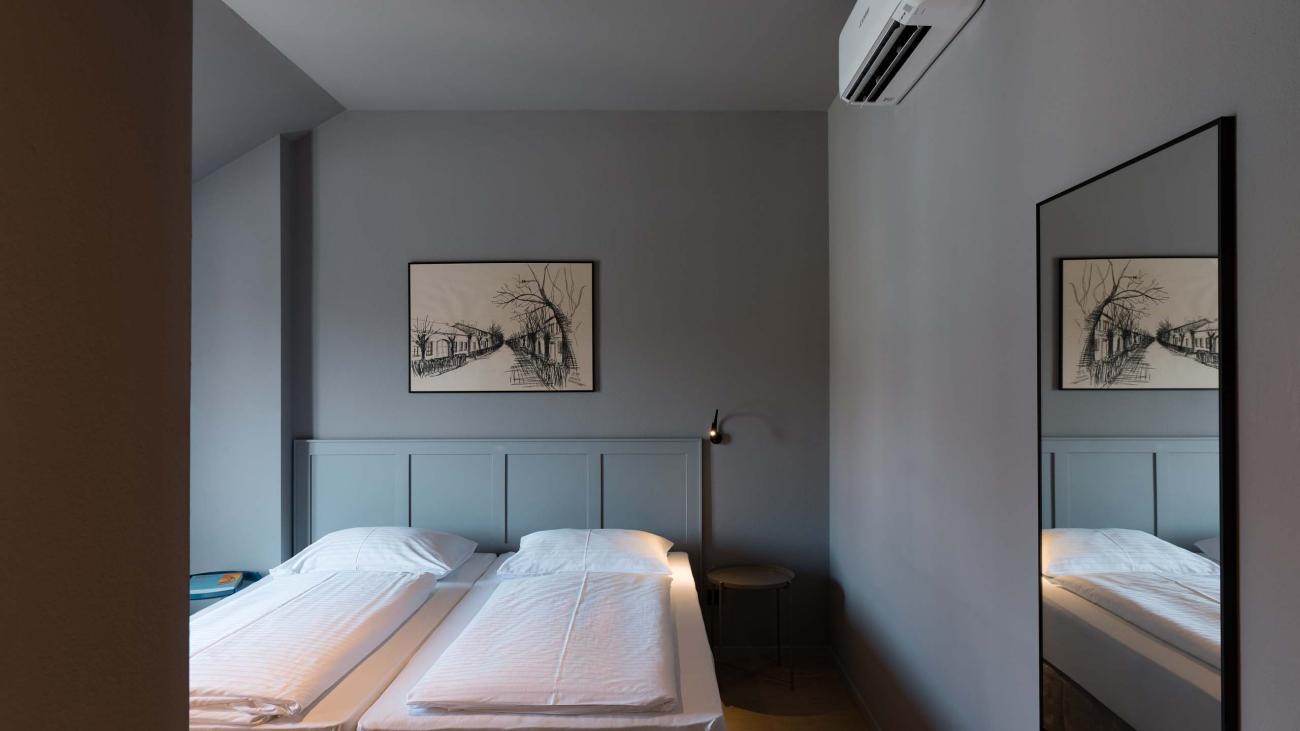 Schlafzimmer mit zwei Betten und Bild, Spiegel an der Wand, Luis v. Weyden