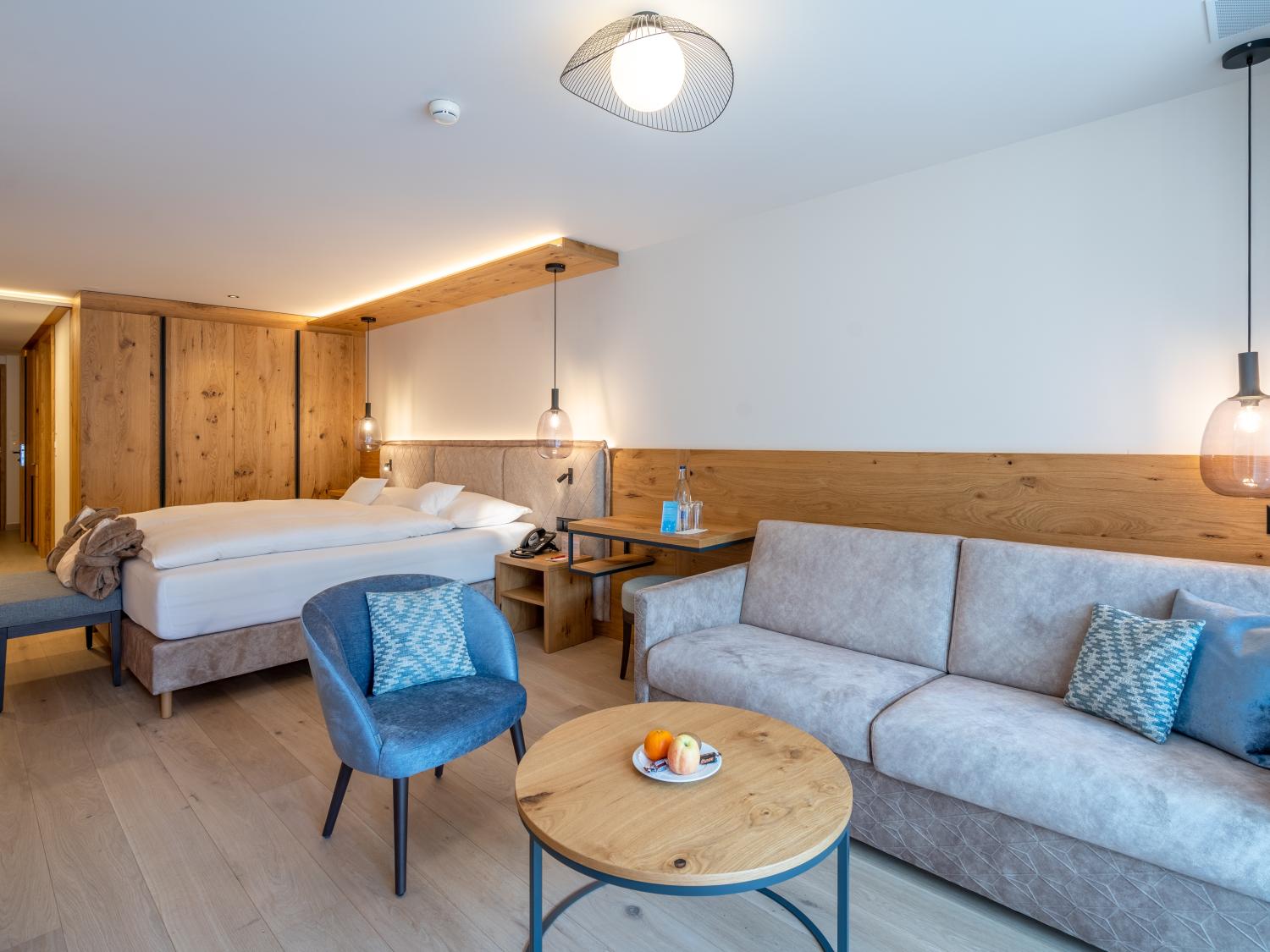 Modern room at Resort La Ginabelle Zermatt with wood accents and seating area