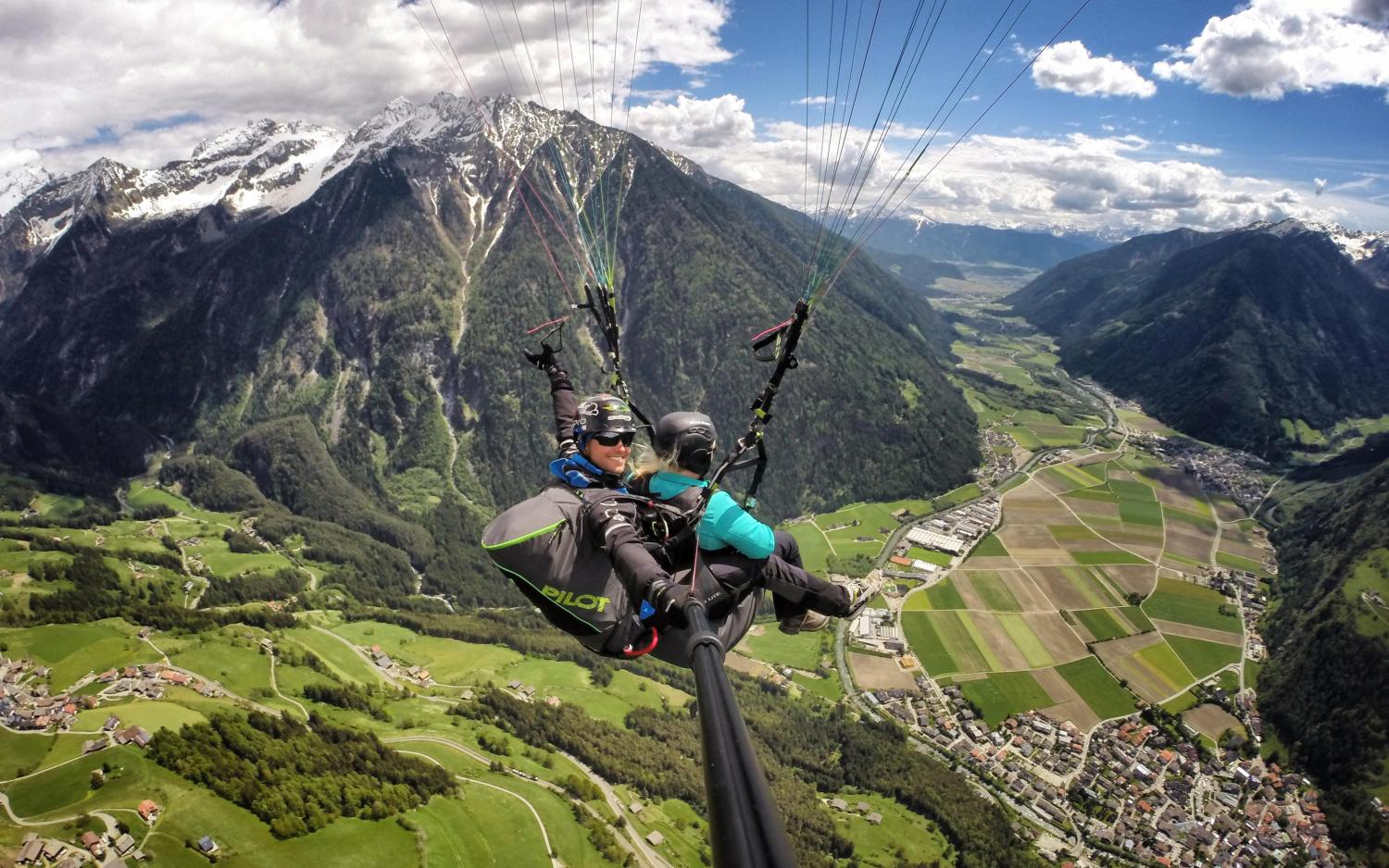 Paragliding over the Alps with view of Hotel Weiher and the valley