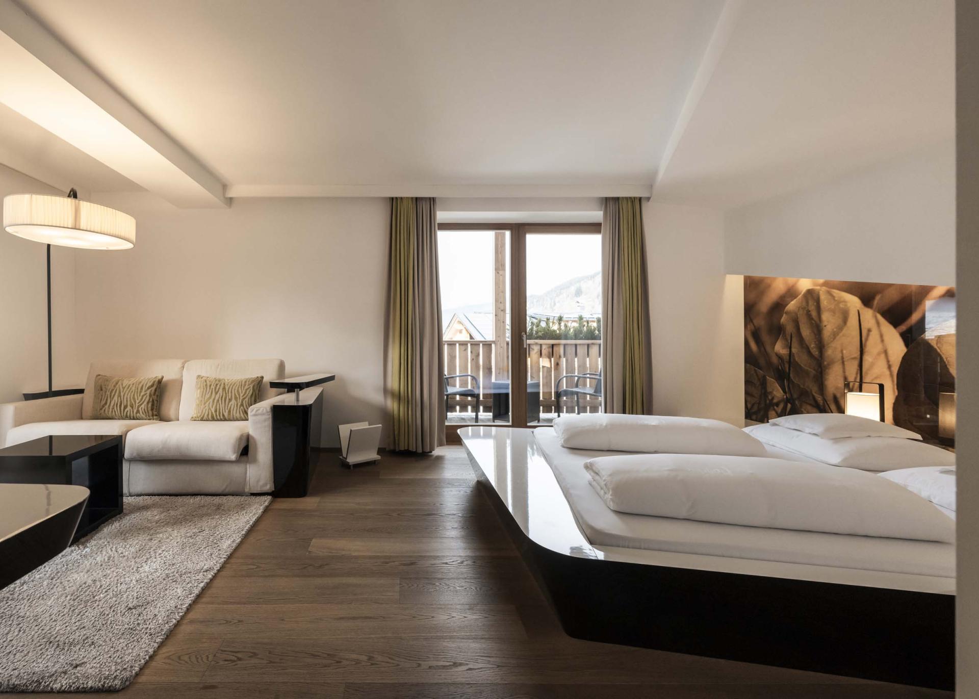 Modernes Hotelzimmer im Hotel Monika mit Bett und Sitzbereich
