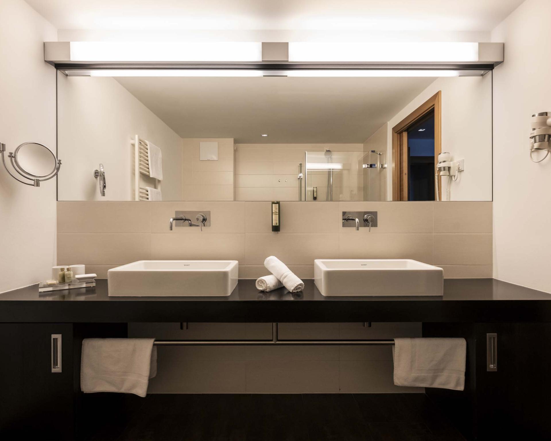 Modernes Badezimmer mit Doppelwaschbecken im Hotel Monika