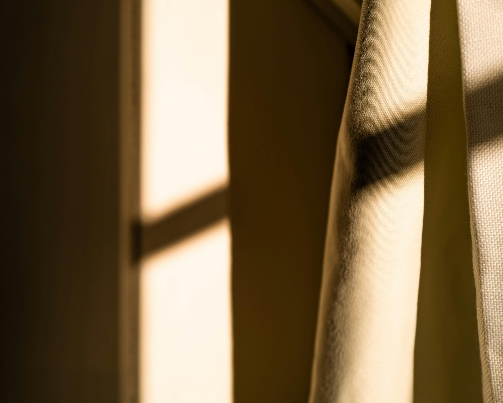Close-up of curtain with sunlight and shadow at Glockna