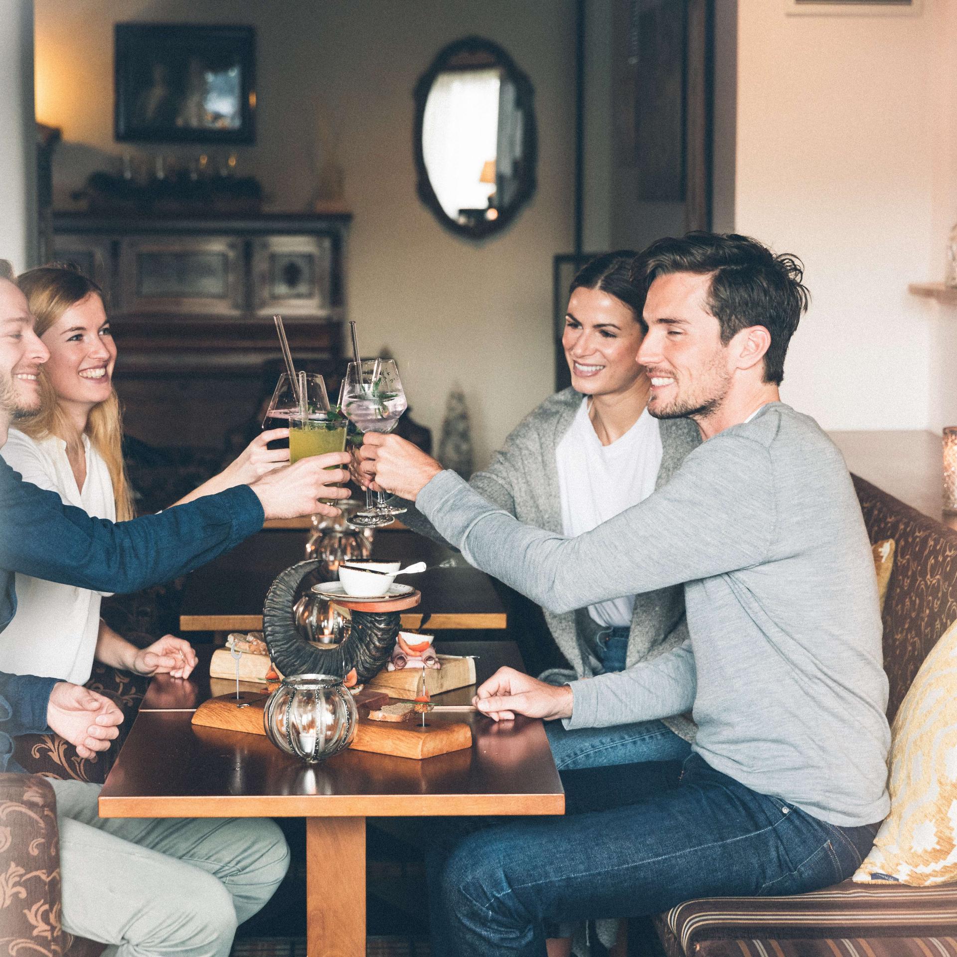 Eibl-Brunner Gäste stoßen im gemütlichen Restaurant mit Getränken an