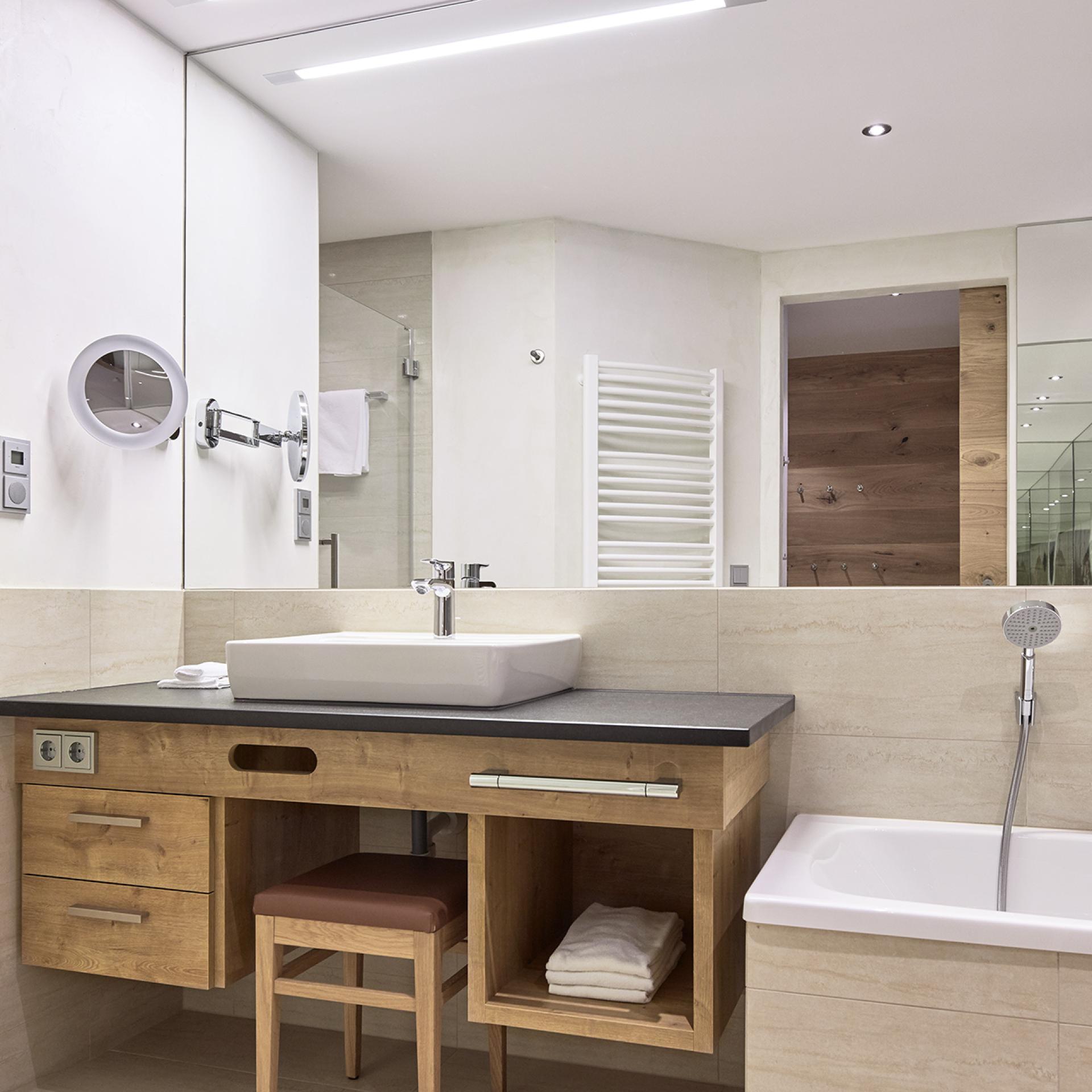 Modern bathroom at Familienresort Buchau with bathtub and shower