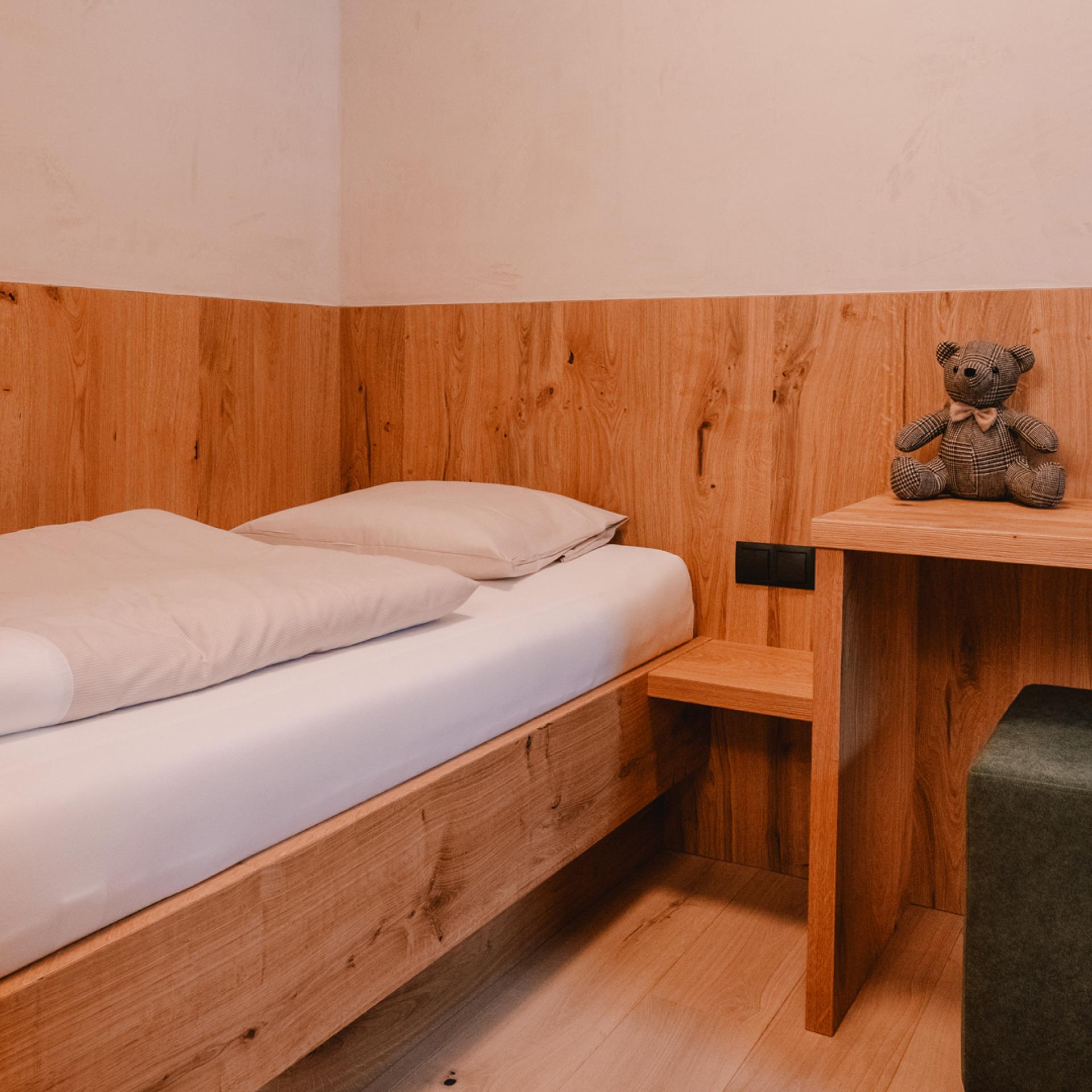 Simple bedroom with bunk bed at Familienresort Buchau