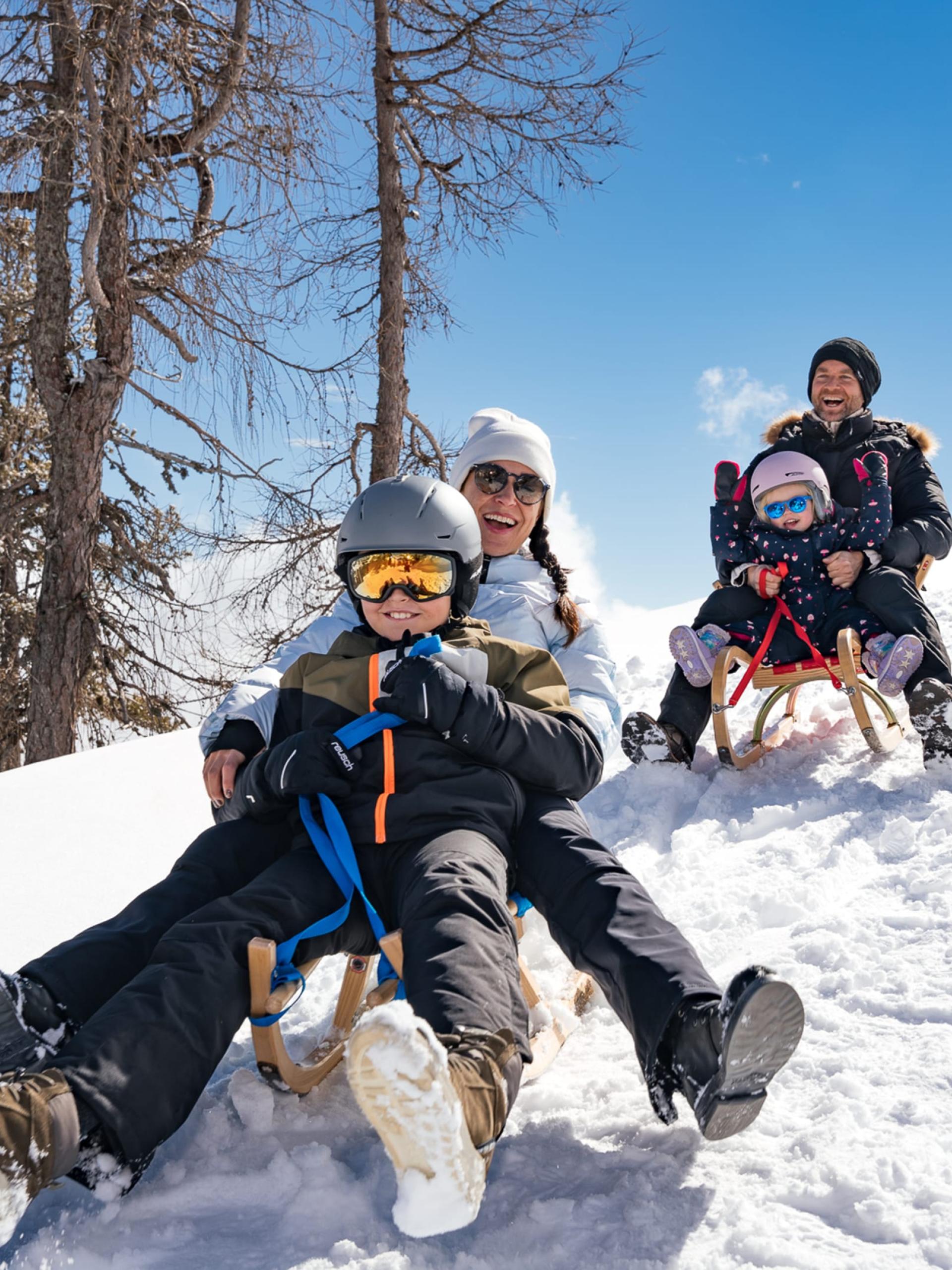 Playground at Familienresort Buchau covered in snow with mountain backdrop