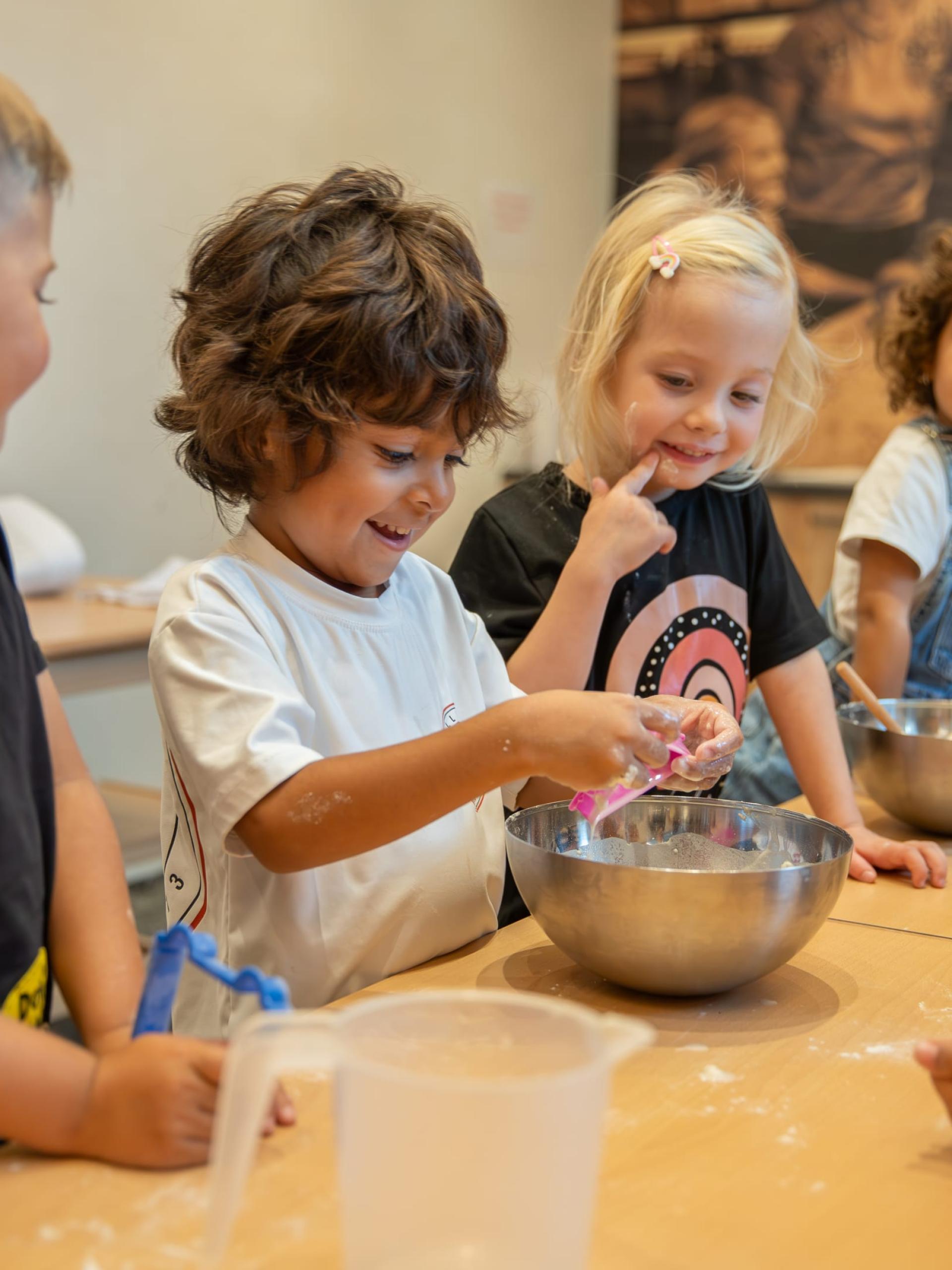 Children baking and playing together at Familienresort Buchau