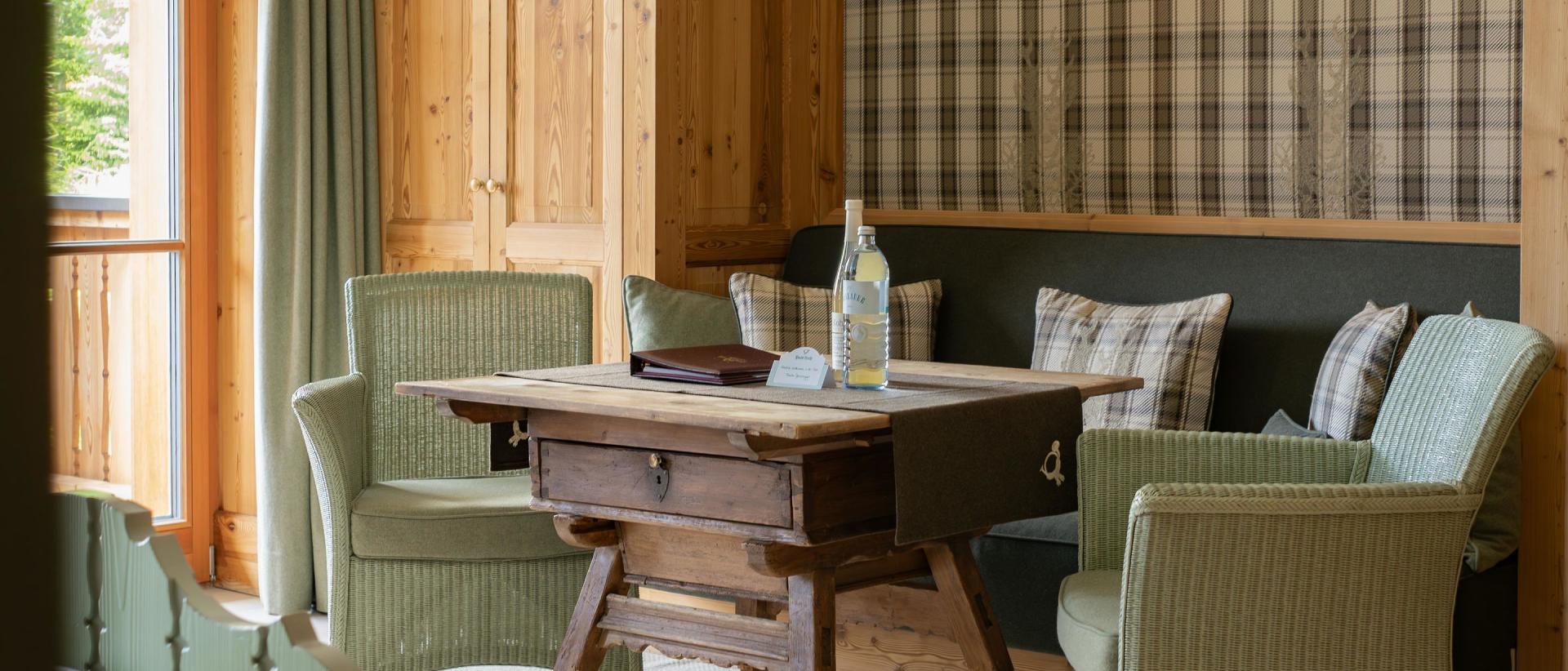 Seating area with wooden table at Hotel Post Lech