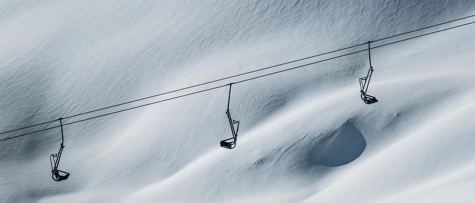 Empty ski lifts above snowy slope at Hotel Aurora