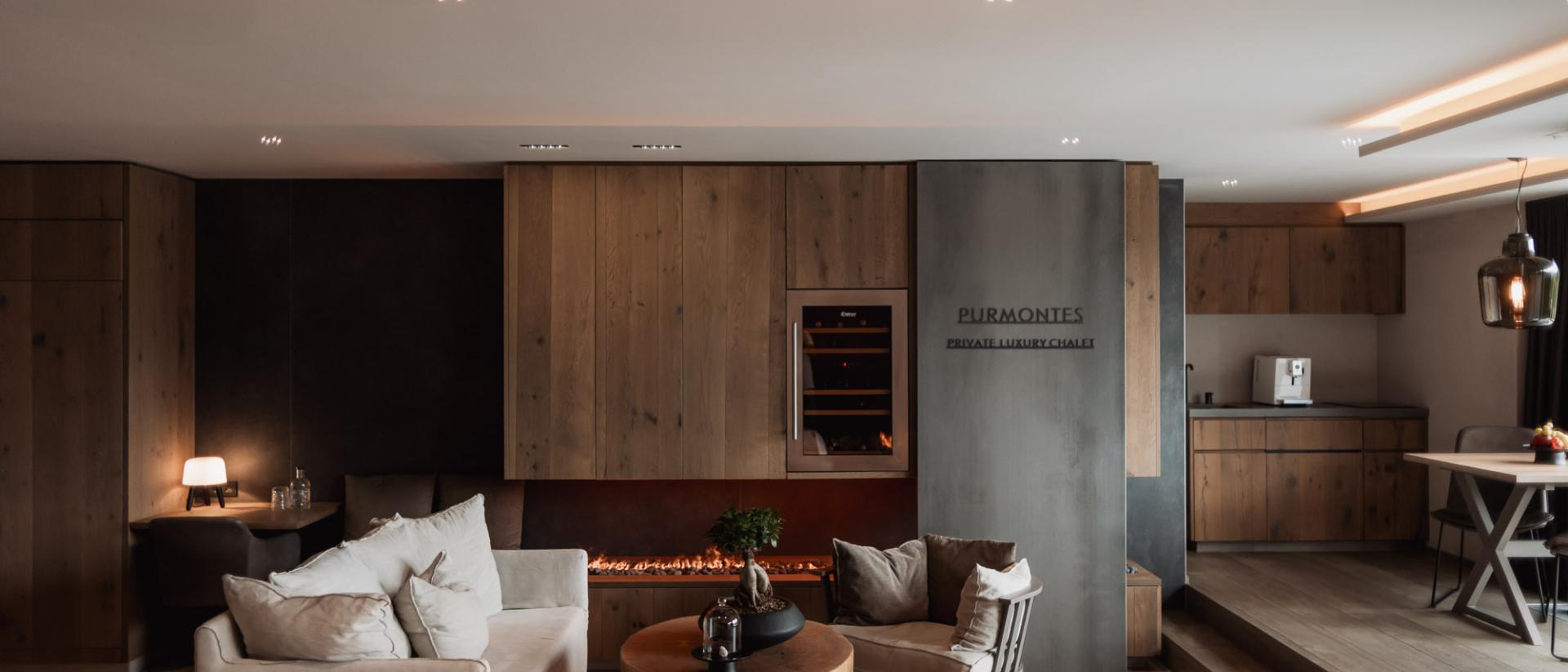 Cozy living area in Chalet Purmontes with fireplace and modern furnishings
