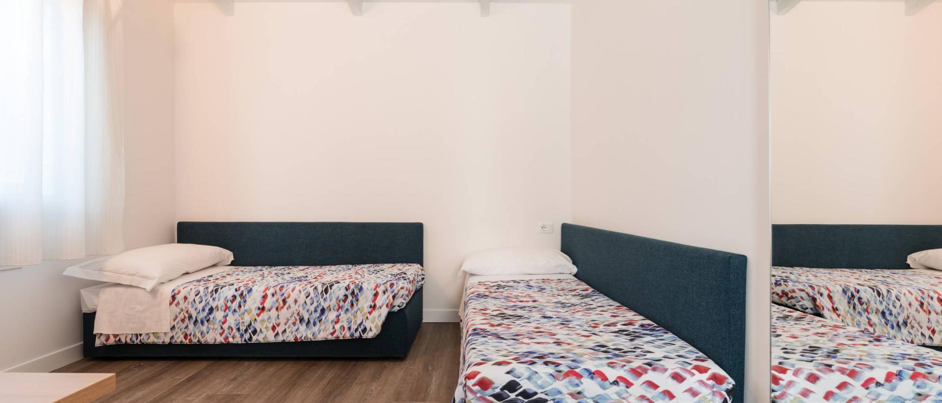 Schlichte Zimmer mit zwei Betten im Natural Village Resort