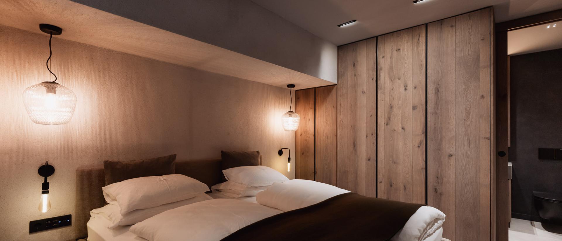 Modernes Schlafzimmer im Chalet Purmontes mit Holzvertäfelung und Doppelbett