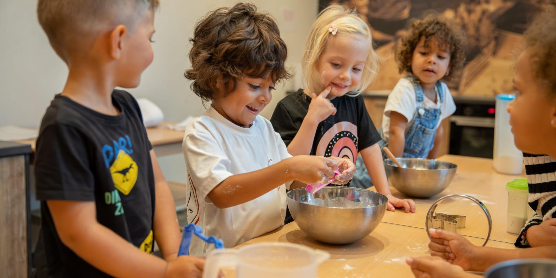 Children baking and playing together at Familienresort Buchau