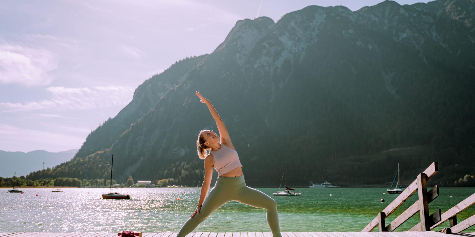 Yoga by the lake at Familienresort Buchau with mountain view
