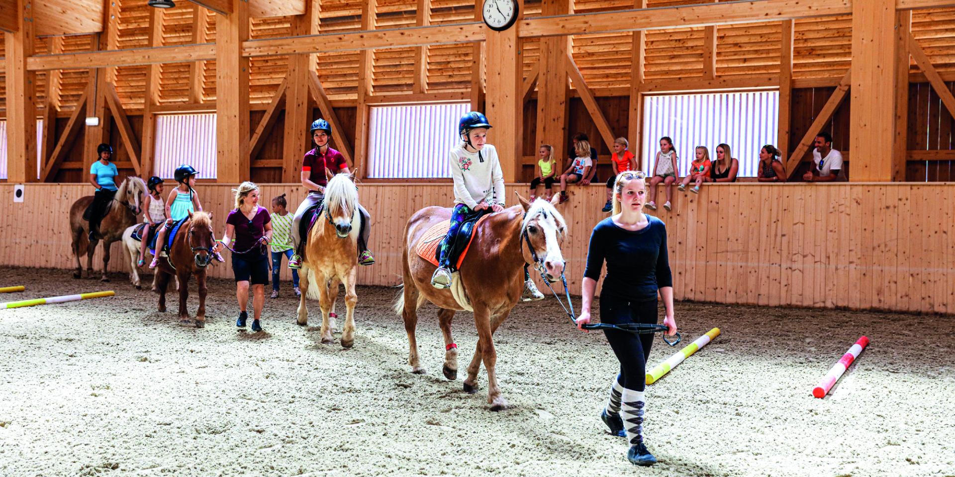 Children pony riding in the arena at Familienresort Buchau