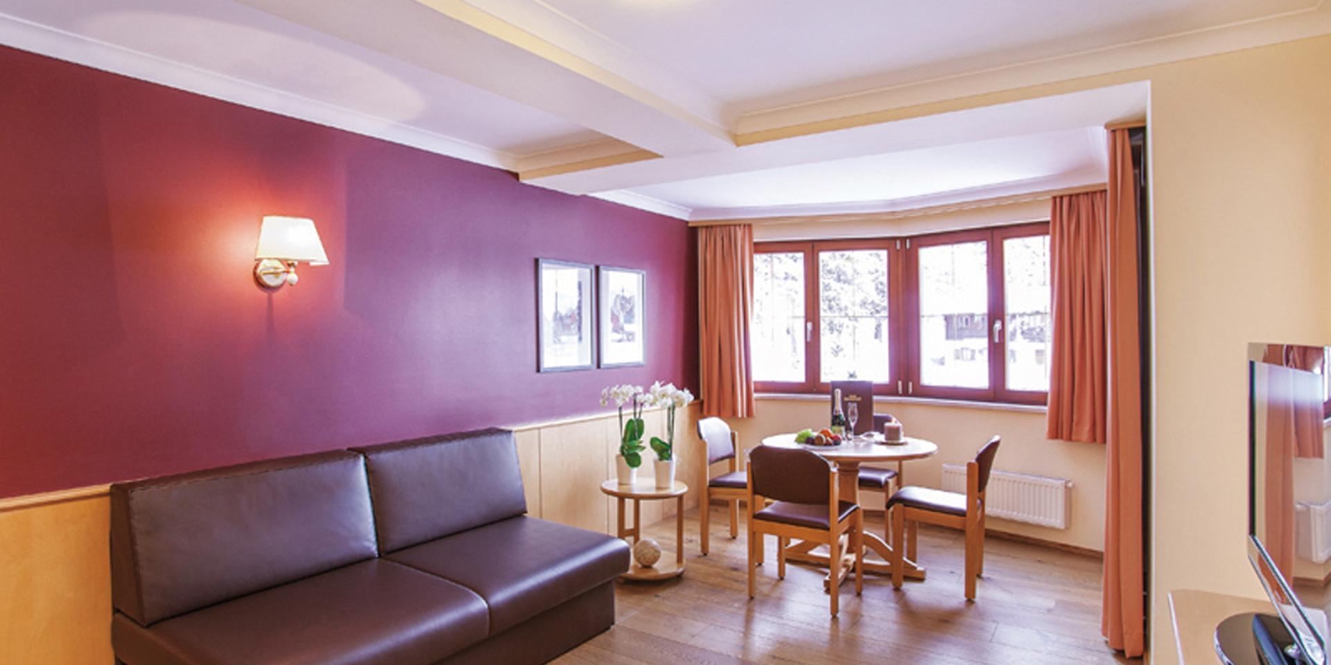 Living room at Familienresort Buchau with sofa and dining table
