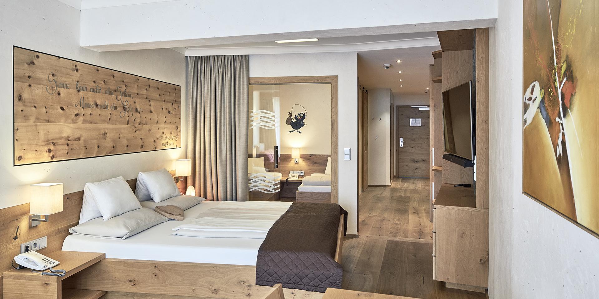 Modern double room at Familienresort Buchau with wooden decor and cozy ambiance