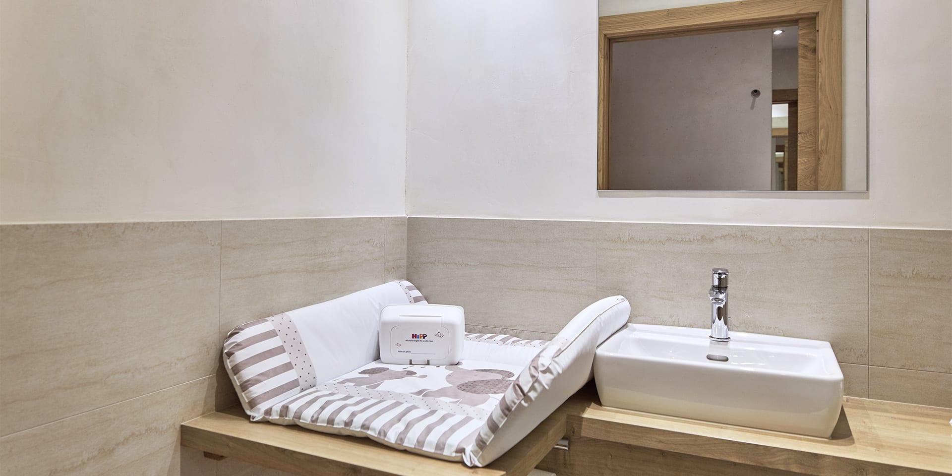Changing area with sink and mirror at Familienresort Buchau