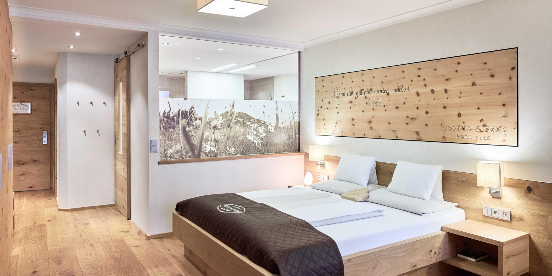 Modern bedroom in Familienresort Buchau with wooden design and double bed
