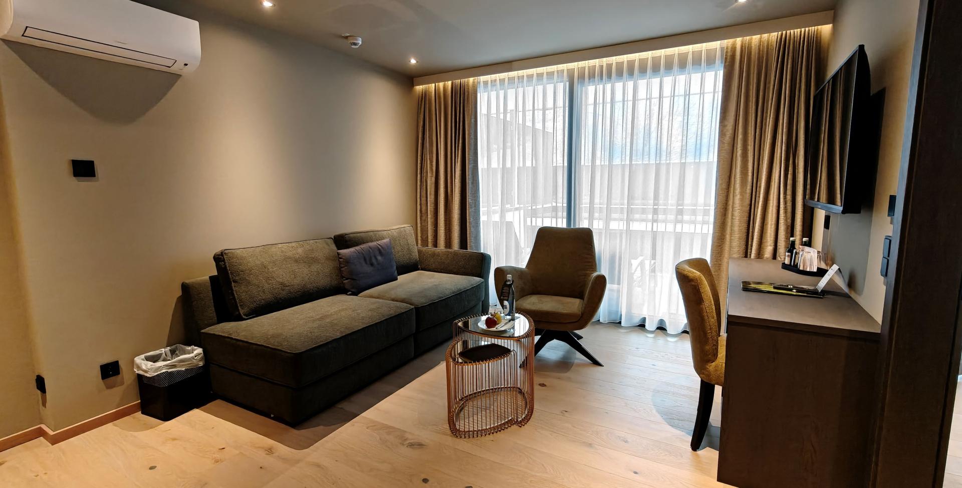Wohnbereich im Sport- und Wellnesshotel Angerhof ****S mit Sofa und Balkon