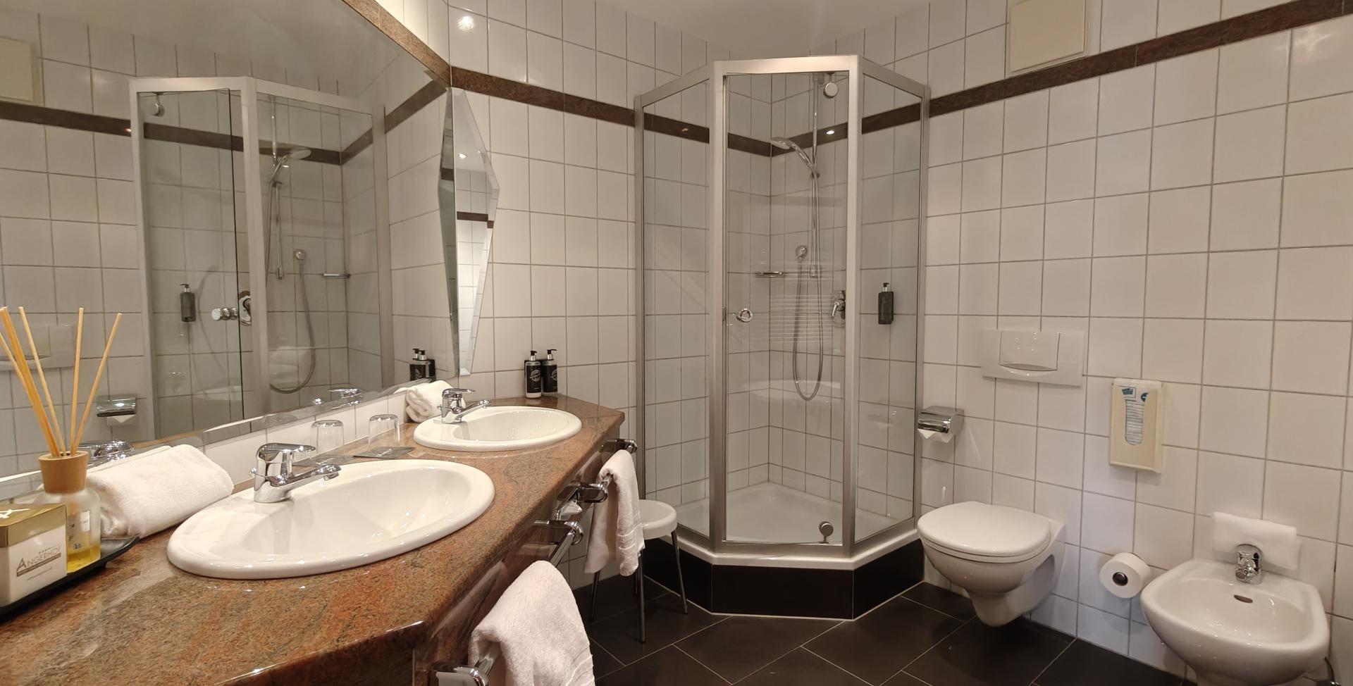 Modernes Badezimmer im Sport- und Wellnesshotel Angerhof ****S mit Doppelwaschbecken und Dusche