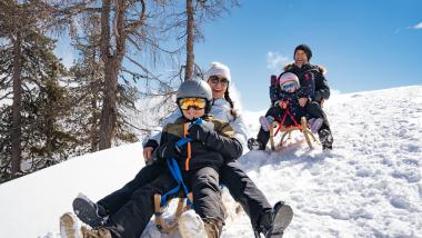 Playground at Familienresort Buchau covered in snow with mountain backdrop