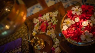 Decorative flowers and candles at The Mangosteen Ayurveda & Wellness Resort