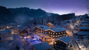 Hotel Gassner **** Superior illuminated in a snowy alpine village beneath a starry sky