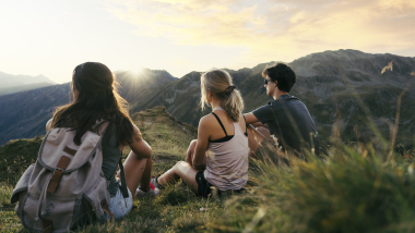 People relaxing at sunset in the mountains at Forster's Naturresort