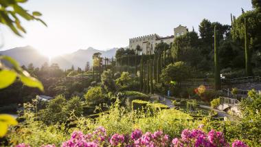 Hotel Adria with garden and mountains at sunset