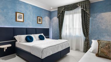 Camera elegante con decorazioni blu all'Hotel Regina Caserta