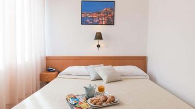 Hotel Viola Gaeta camera con vassoio per la colazione sul letto e quadro sulla parete