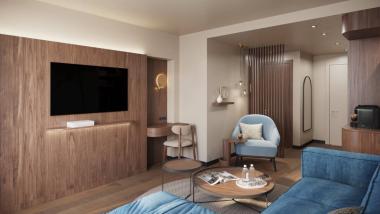 Cozy living area at Krumers Alpin with wood paneling and blue armchairs