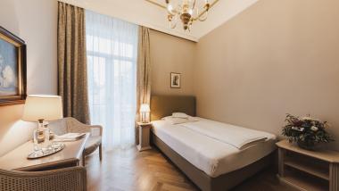 Cozy single room at Hotel Adria with classic furniture and bed