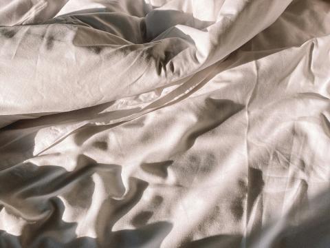 Verwobene weiße Bettwäsche im Hotel Aurora