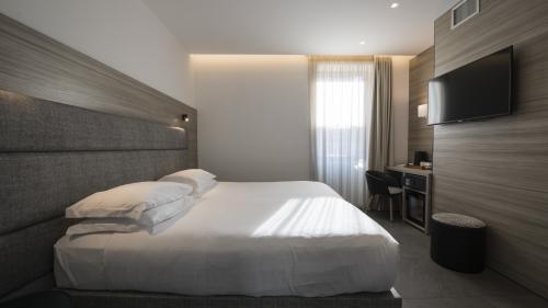Modern hotel room at Hotel Touring Verona with sofa and TV