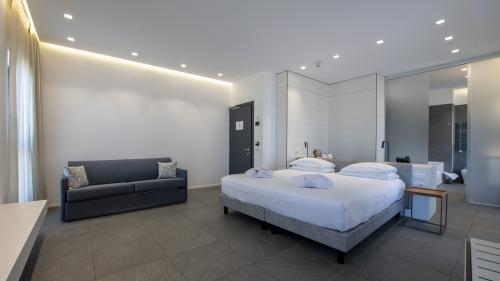 Modern hotel room at Hotel Touring Verona with double bed and sofa