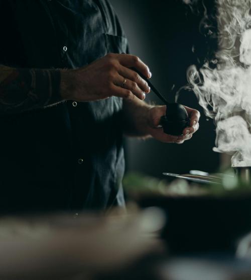 Koch bereitet dampfendes Gericht im Resort La Ginabelle Zermatt zu