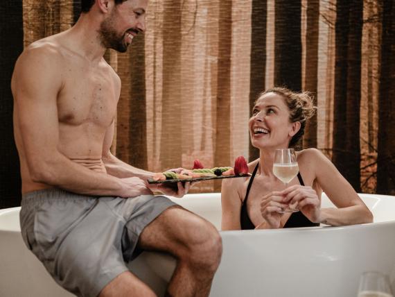 Elgus Nature Retreat: couple relaxing in a bathtub with fruit and wine