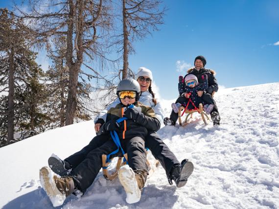 Playground at Familienresort Buchau covered in snow with mountain backdrop