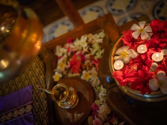 Decorative flowers and candles at The Mangosteen Ayurveda & Wellness Resort