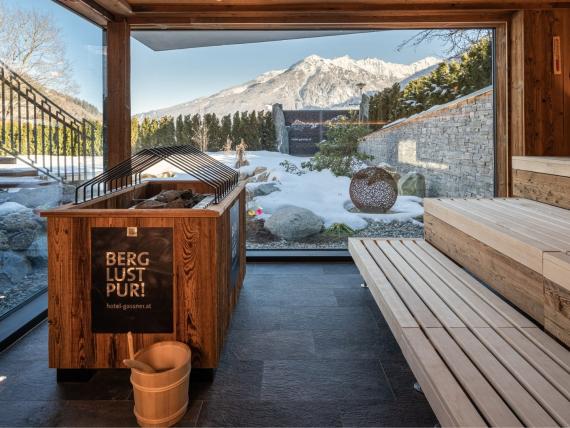 Wooden sauna at Hotel Gassner **** Superior overlooking a snow-covered mountain landscape