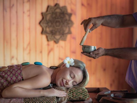 Woman receiving traditional Ayurveda treatment at The Mangosteen Ayurveda & Wellness Resort